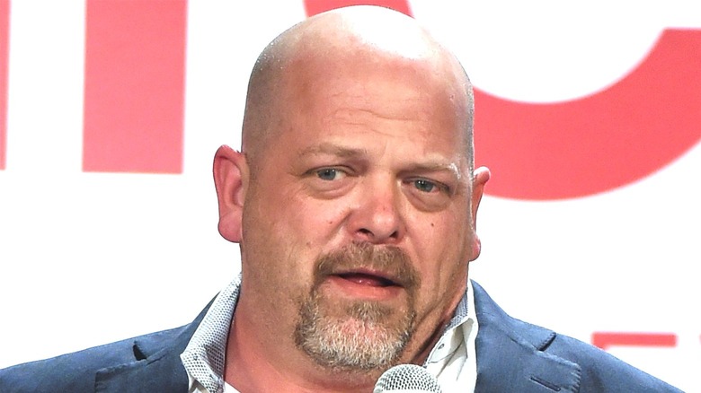 Rick Harrison speaking into microphone