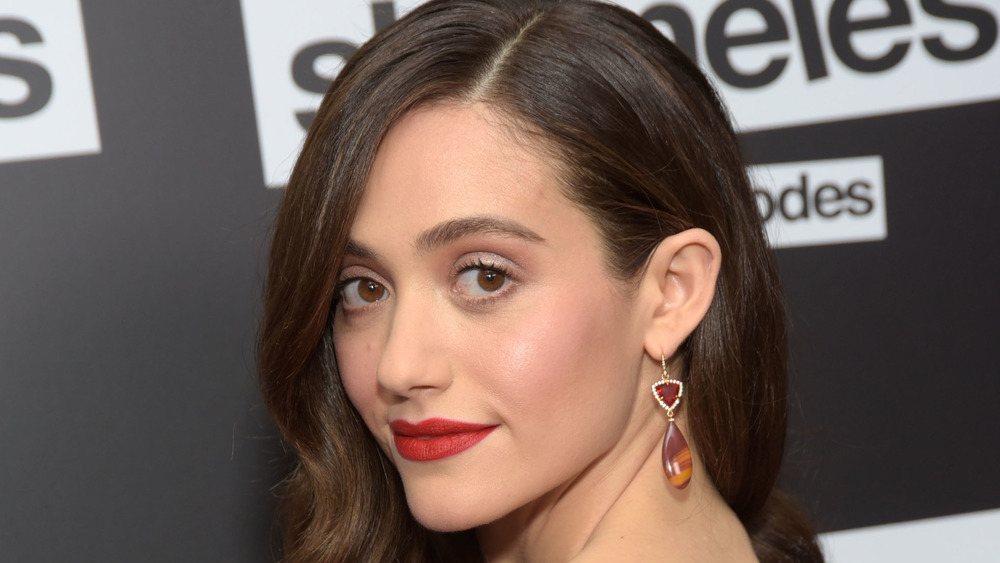 Emmy Rossum walks a red carpet in close-up