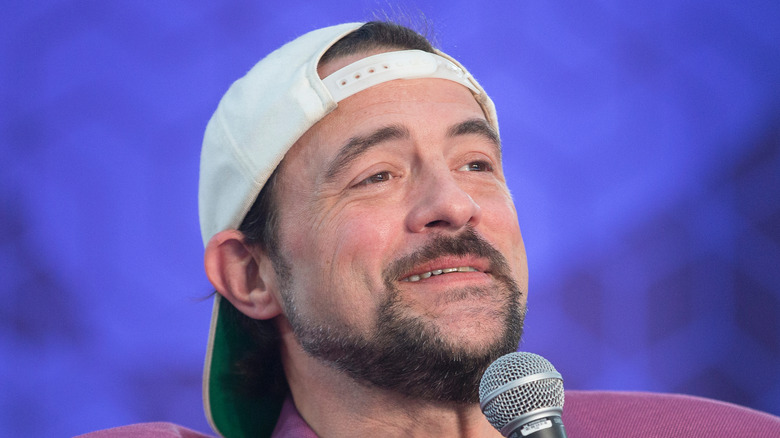 Kevin Smith speaking into a mic