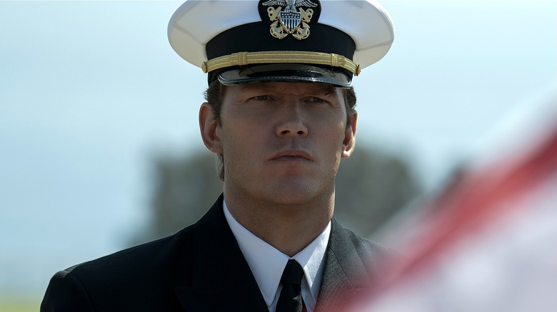 James Reece standing behind an American flag in 