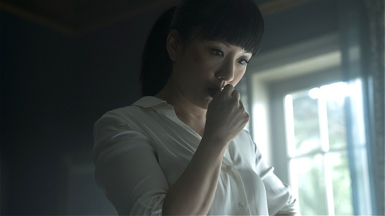 Katie Buranek thinking with her hand on her mouth in "The Terminal List"