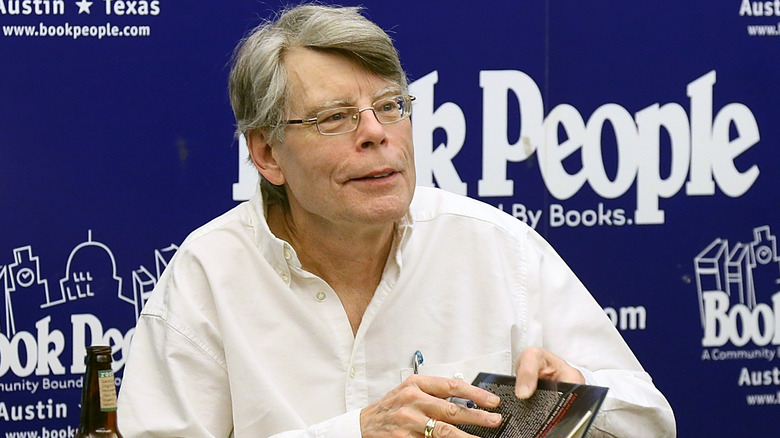Stephen King signing copies of his book 