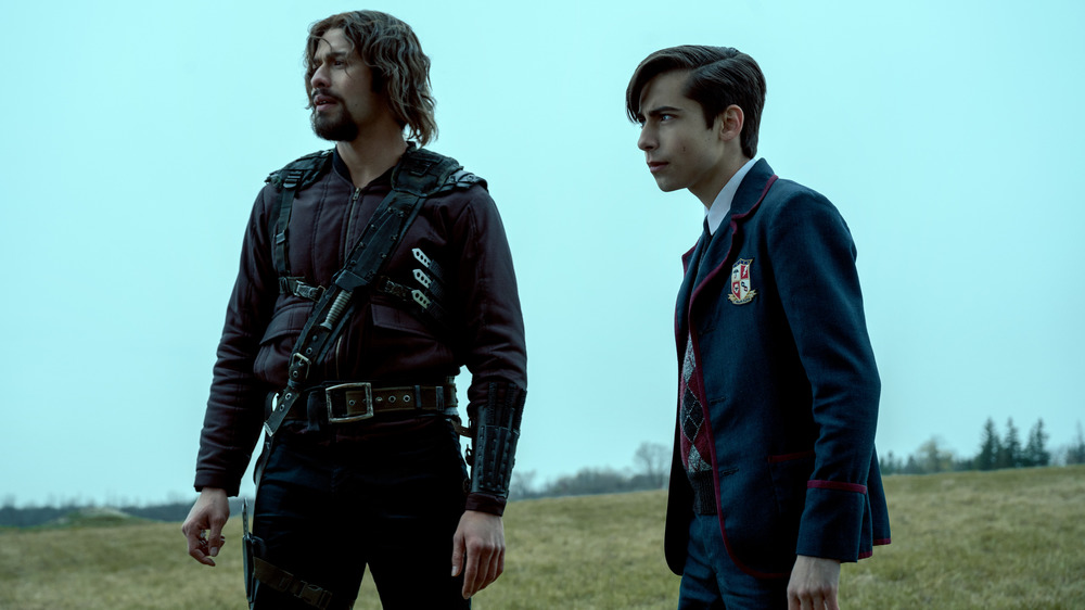 Diego and Five stand on a hill