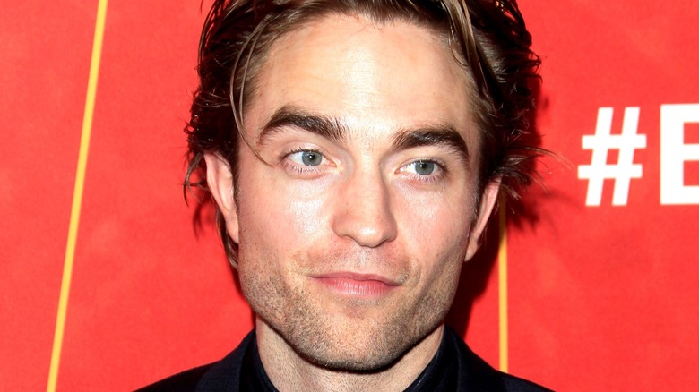 Robert Pattinson smiles on red carpet