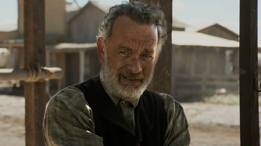 Tom Hanks stands in a frontier town