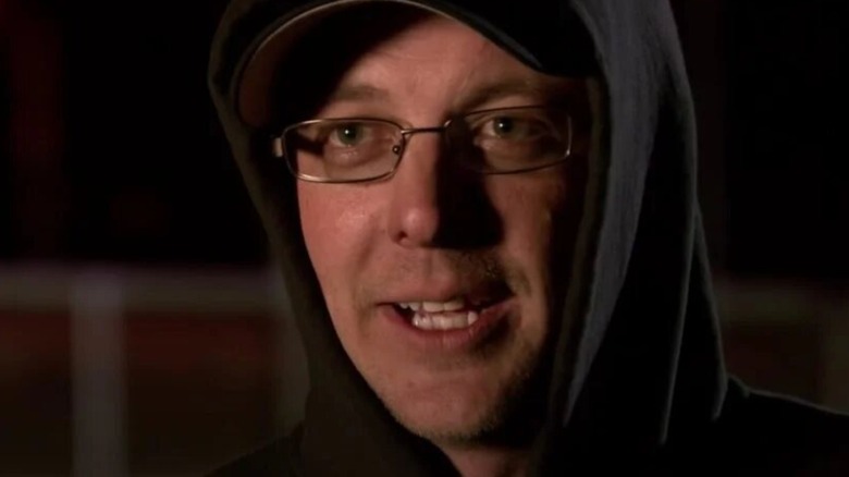 Tyler "Flip" Priddy speaking, hooded, in close-up