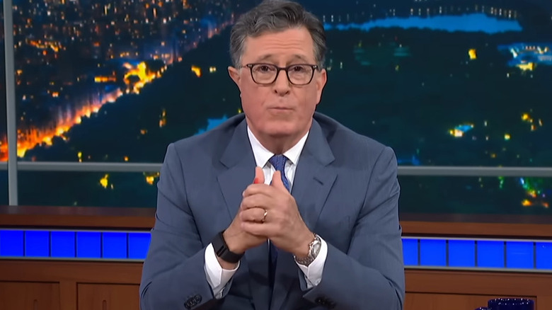 Stephen Colbert with his hands together on "The Late Show with Stephen Colbert" (2015-present)