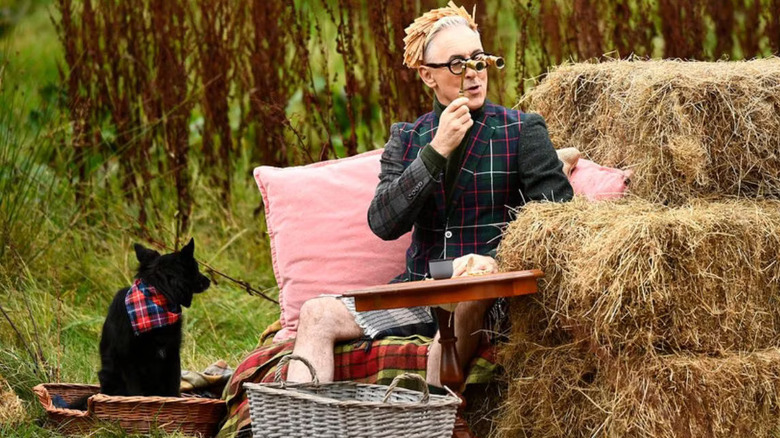Alan Cumming and his dog Lala hosting The Traitors