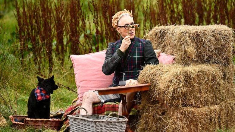 Alan Cumming and his dog Lala hosting The Traitors