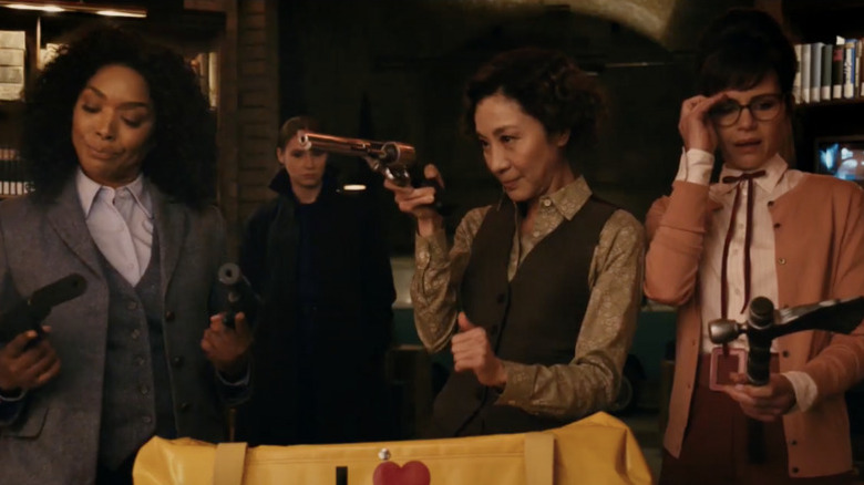 Madeleine with the other assassins checking guns