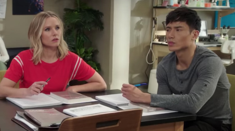 Manny Jacinto and Kristin Bell studying in The Good Place