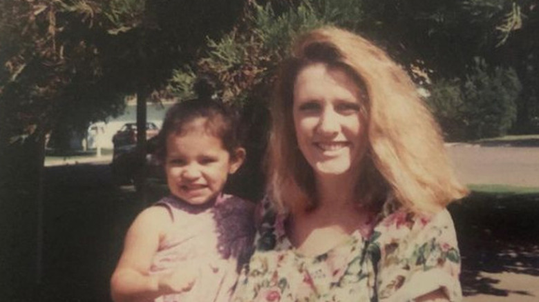 A young Miranda Rae Mayo smiling with her mom