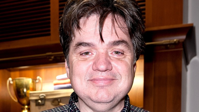 Oliver Platt in front of trophy case