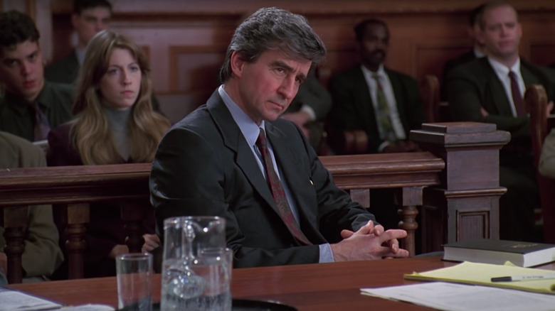 Jack McCoy listens intently from behind a desk in a courtroom