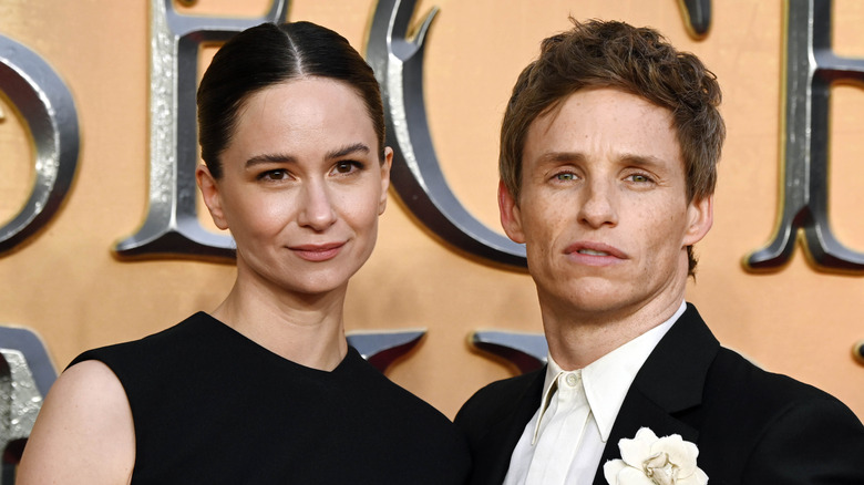 Katherine Waterston and Eddie Redmayne pose at a red carpet event