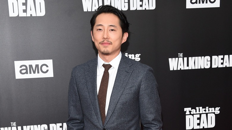 Steven Yeun posing for pictures