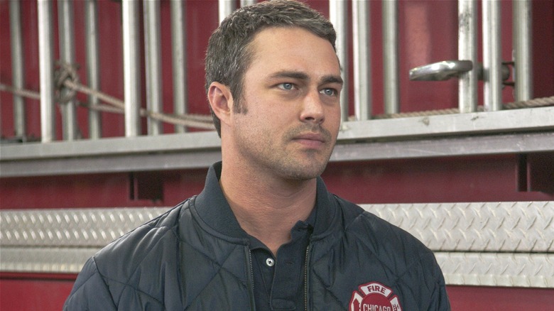Kelly Severide standing by firetruck in Chicago Fire