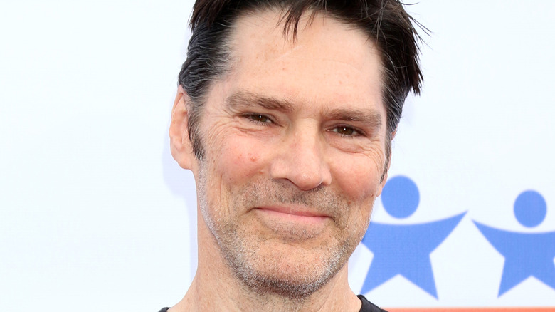 Thomas Gibson leaning against wall