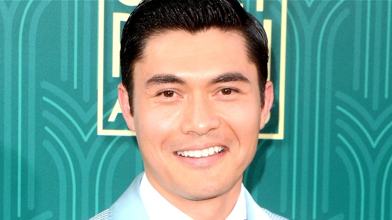 Star Henry Golding poses at event 