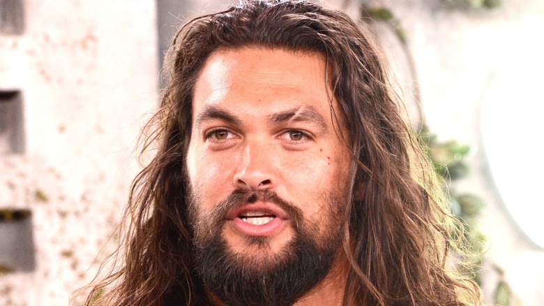 ECU of Jason Momoa hair down speaking