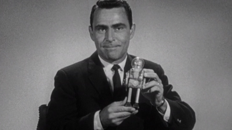 Rod Serling holding an astronaut toy in 