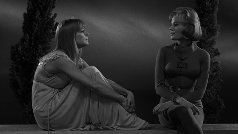 Marilyn Cuberle and Valerie sitting side by side on a parapet
