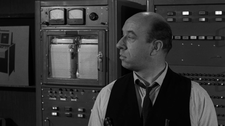 Wallace V. Whipple standing next to a machine
