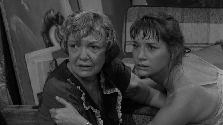 Norma holding Mrs. Bronson's shoulder while both look worriedly in the same direction