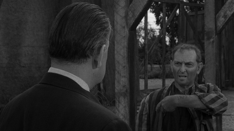 The ghost of concentration camp prisoner Alfred Becker holds up his tattooed arm in "Deaths-Head Revisited" (1961)