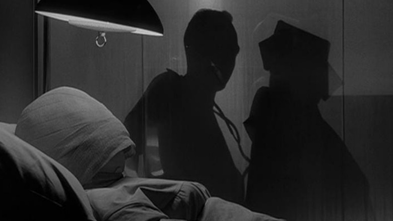 Janet Tyler masked in hospital bed next to two shadowed figures on The Twilight Zone (1959-1964)