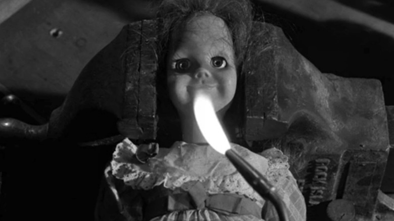 Talky Tina sits menacingly behind fire on The Twilight Zone (1959-1964)