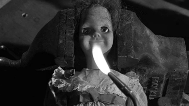 Talky Tina sits menacingly behind fire on The Twilight Zone (1959-1964)