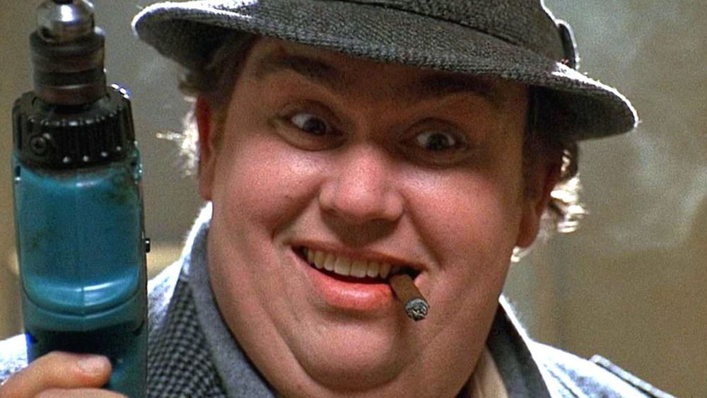 John Candy as Uncle Buck with electric drill smoking a cigar