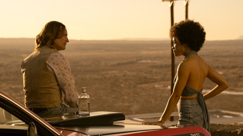 Jim talking to Nina at a scenic overlook in Duster (2025)