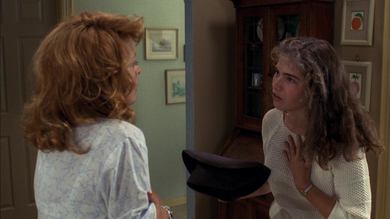 Nancy holds Freddy's hat