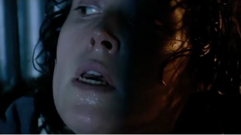 Ripley hiding from the xenomorph in Alien