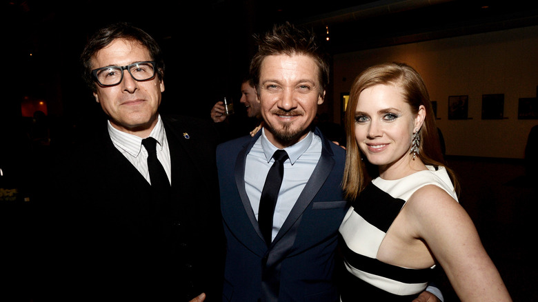 David O. Russell, Jeremy Renner and Amy Adams posing and smiling