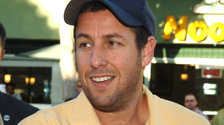 Adam Sandler wearing yellow shirt