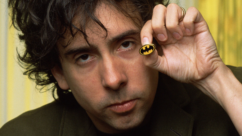 Tim Burton holds Batman pin