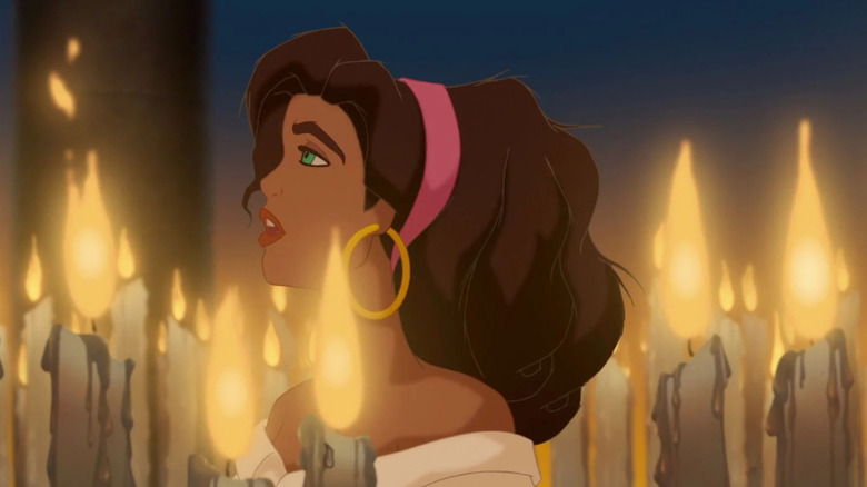 Esmeralda walking past candles