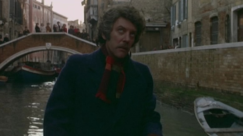 John Baxter wading through canal in Venice