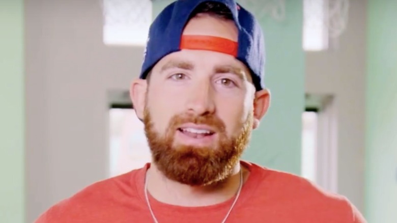 Tyler Toney wearing a blue and red baseball cap