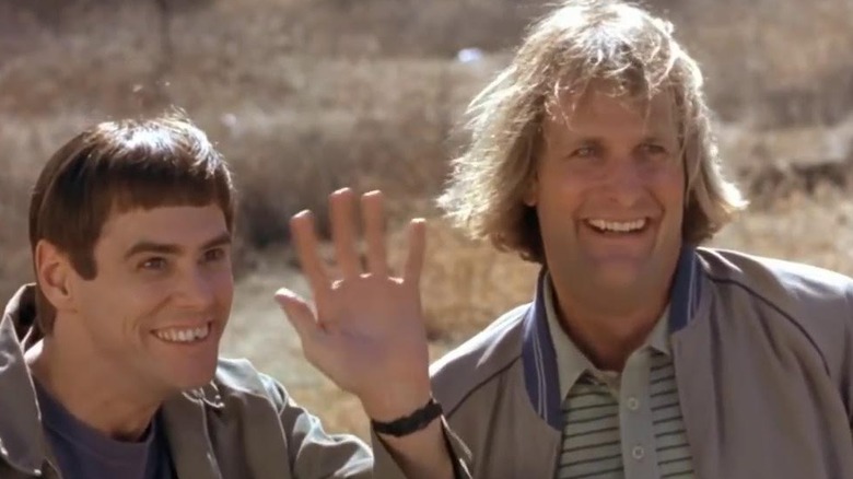 Harry and Lloyd in front of bus full of women