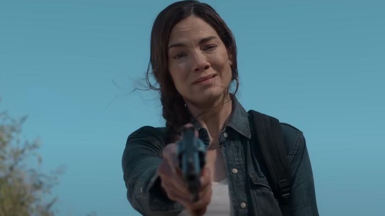 Leni pointing a gun and crying