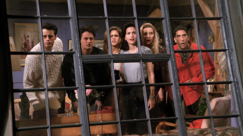 Friends looking out Monica's window