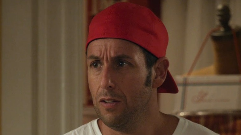 Adam Sandler wearing a backwards cap