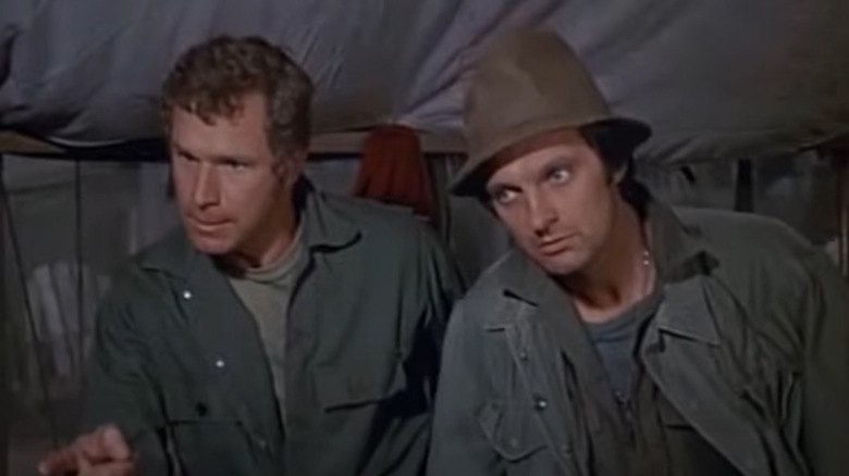 Hawkeye and Trapper John looking serious