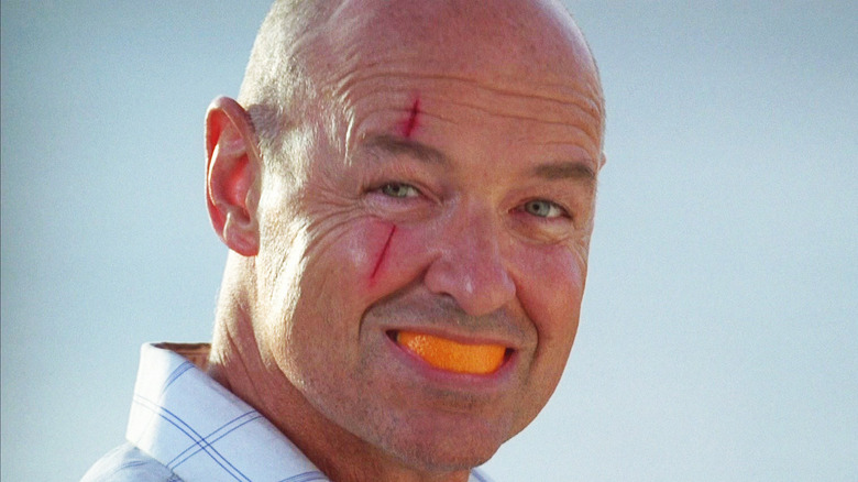 Locke smiling with orange in mouth