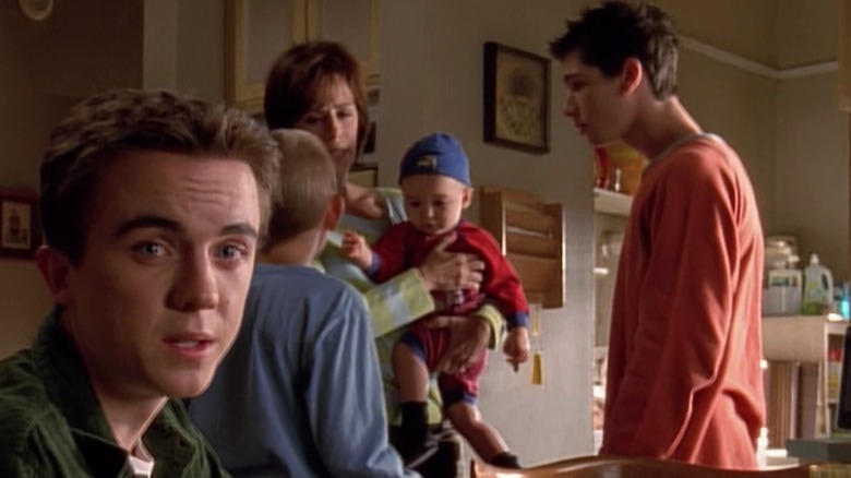 Malcolm looks directly at camera