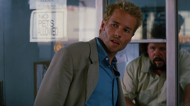 Guy Pearce at a hotel reception desk